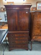 A mahogany drinks cabinet in the style of a Victorian linen press. COLLECT ONLY.