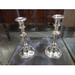 A pair of Victorian silver plated candlesticks dedicated in 1944