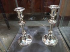 A pair of Victorian silver plated candlesticks dedicated in 1944