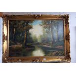 A gilt framed oil on canvas of a River scene signed Dunn 75 x 105 cm