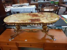 A Vintage oval coffee table on brass base and with onyx top. COLLECT ONLY.