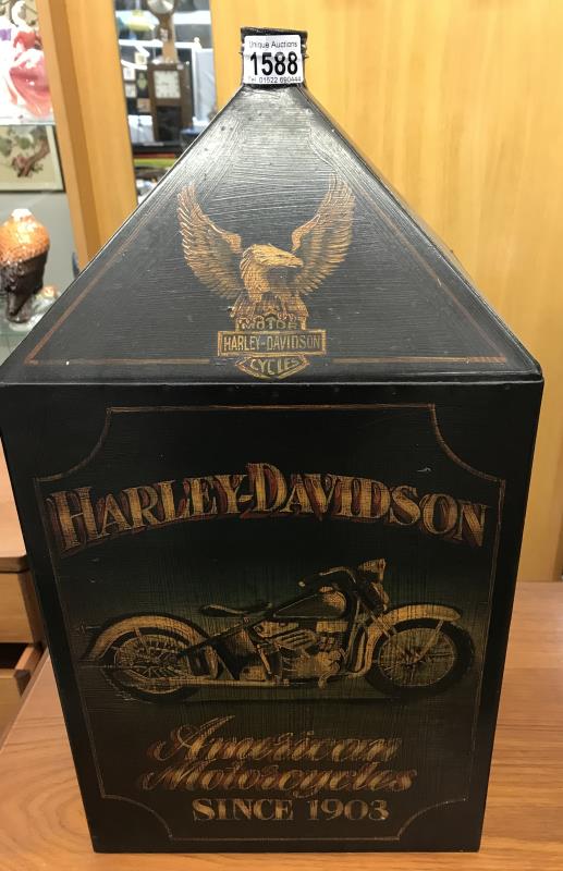 An old painted tin canister with top ( Harley Davidson).