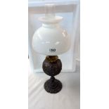 An oil lamp 19th century cast iron with later shade, Shade A/F