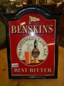 An old Benskins Best Bitter enamel sign in cast metal wall mount with wooden backing, COLLECT ONLY.