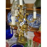 A candelabra style gilt table lamp supported by a cherub. COLLECT ONLY.