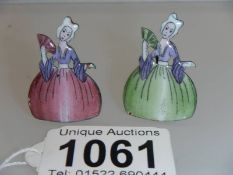 A pair of early 20th century crinoline lady place card holders, 3.5 cm tall.