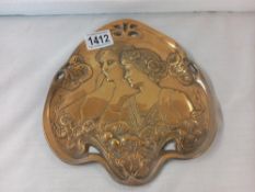 An Art Nouveau brass tray portraying head and shoulders of two young ladies in style of WMF