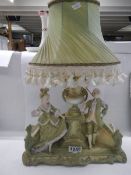 A Regency figure group table lamp with shade, (chip to right side), COLLECT ONLY.