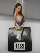 A ceramic pipe hand painted with a female figure.