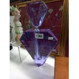 A large oversize perfume bottle in purple