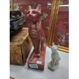 Two Egyptian cat figurines - one larger in red stone the smaller in a white stone