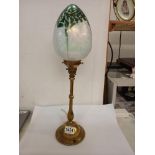 A 1930s brass table lamp with Tiffany style shade