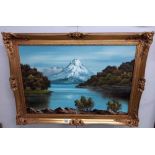 A gilt framed oil on canvas Lakeside Mountain scene signed Rocky 62 x 87 cm