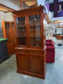 A darkwood stained bookcase/display cabinet with cupboard. COLLECT ONLY.