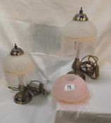A pair of table lamps with beaded glass shades and a spare beaded shade