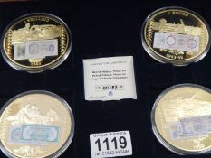 A cased set of four large military themed coins.