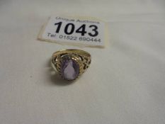 A large oval amethyst yellow gold ring, size J half, 2.5 grams.