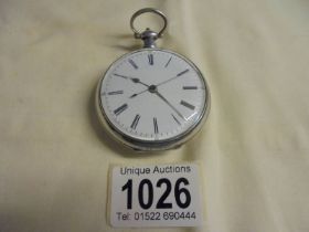 A silver pocket watch, in working order.