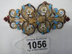 An early to mid 20th century enamel buckle.