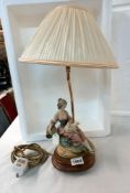 A Capodimonte figural lamp of sitting lady with lamb, with shade