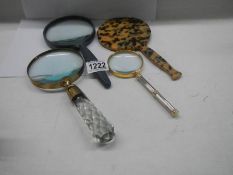 Three good magnifying glasses and a hand mirror.
