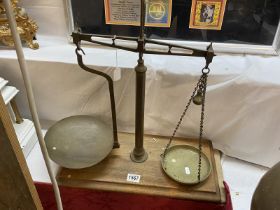 A 19th / 20th Century brass balance scales on oak base