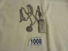 A silver ingot on a silver chain and a silver pendant on a silver chain, 54 grams.