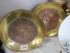 A pair of brass wall plaques with copper centres (possibly Arabic).