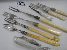 Six pickle forks, a cake slice and one other item (including five silver).