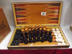 A boxwood chess set with draughts in games box