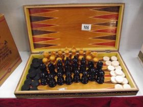 A boxwood chess set with draughts in games box