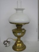 An old brass oil lamp complete with shade. COLLECT ONLY.