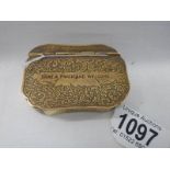 A 19th century brass snuff box inscribed 'Take a Pinch and Welcome'.