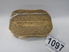 A 19th century brass snuff box inscribed 'Take a Pinch and Welcome'.