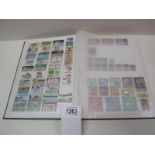 A stamp album with several complete pages of world stamps.