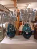 A fine pair of large blue glass based lamps with ornate filigree style shades with hanging lustres