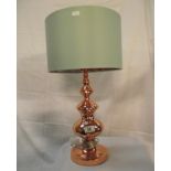 An ornate copper table lamp with green shade (copper design inside shade)