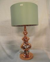An ornate copper table lamp with green shade (copper design inside shade)