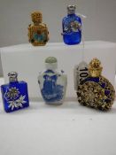 Five ornate perfume bottles including blue glass, Chinese etc.,