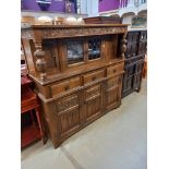 A 1930's solid oak buffet with lead glazed doors. COLLECT ONLY.