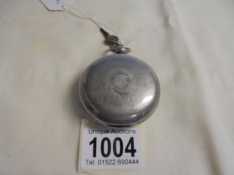 A silver pocket watch with key, dial cracked and not working. - Image 2 of 6