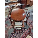 A darkwood stained extending dining table with five chairs. COLLECT ONLY.