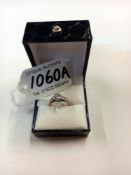 A vintage white stone set ring shoulders set with hearts in 9ct gold