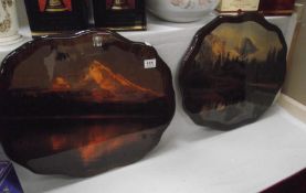 A pair of lacquered prints of mountain sscenes on wooden panels COLLECT ONLY