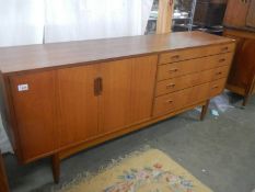 A four drawer/two door teak sideboard, COLLECT ONLY.