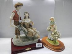 Two 20th century figures - couple and flower girl.