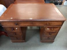 An oak pedestal writing desk with brown leatherette top. COLLECT ONLY.
