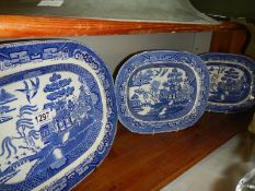 Three blue and white willow pattern platters.