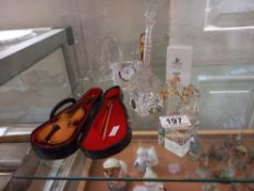 A quantity of crystal glass ornaments including Swarovski, a banjo plus a small violin in case