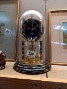 A glass-domed anniversary clock - Collect only